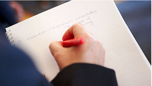 Woman writing on notebook