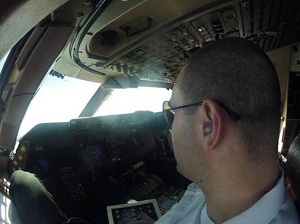 Airline pilot wearing flat-attenuation musicians earplugs during commercial flights