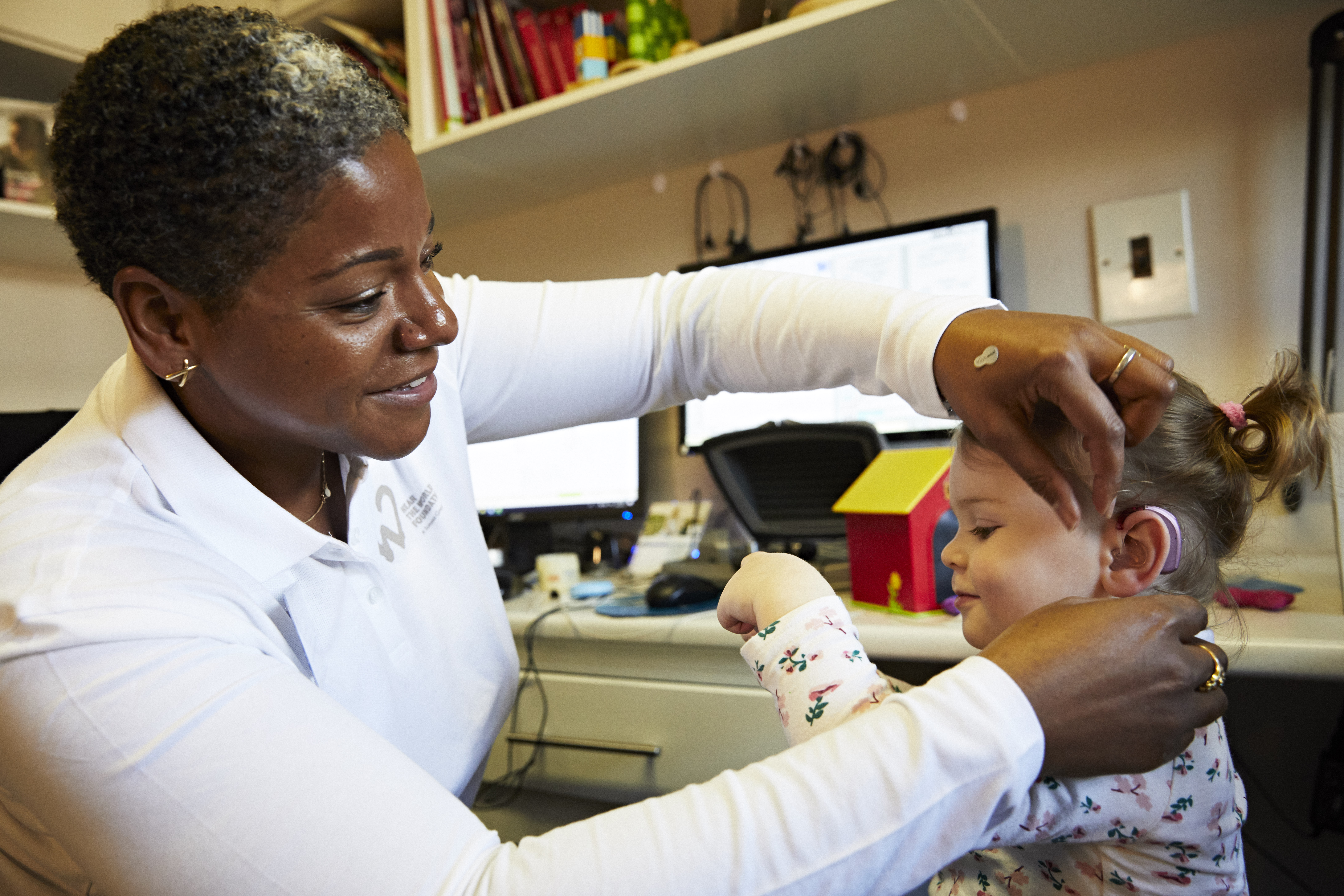 Doctor and patient with hearing aid fitment equipment