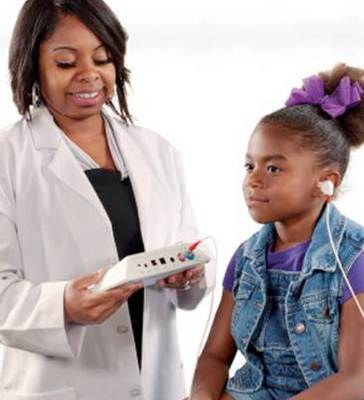doctor and patient with hearing screening device