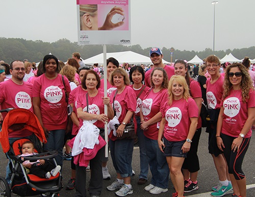 Oticon employees showing their support for breast cancer awareness