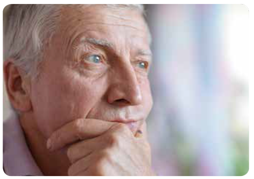 Headshot of an older white male with his chin in his hands looking thoughtful. 