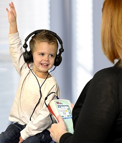 Patient and doctor with instrumentation for screening and diagnostic audiology