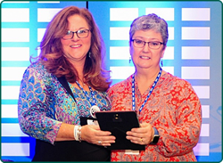 Angela Morris presenting Jana Brown with the Leo Doerfler Award