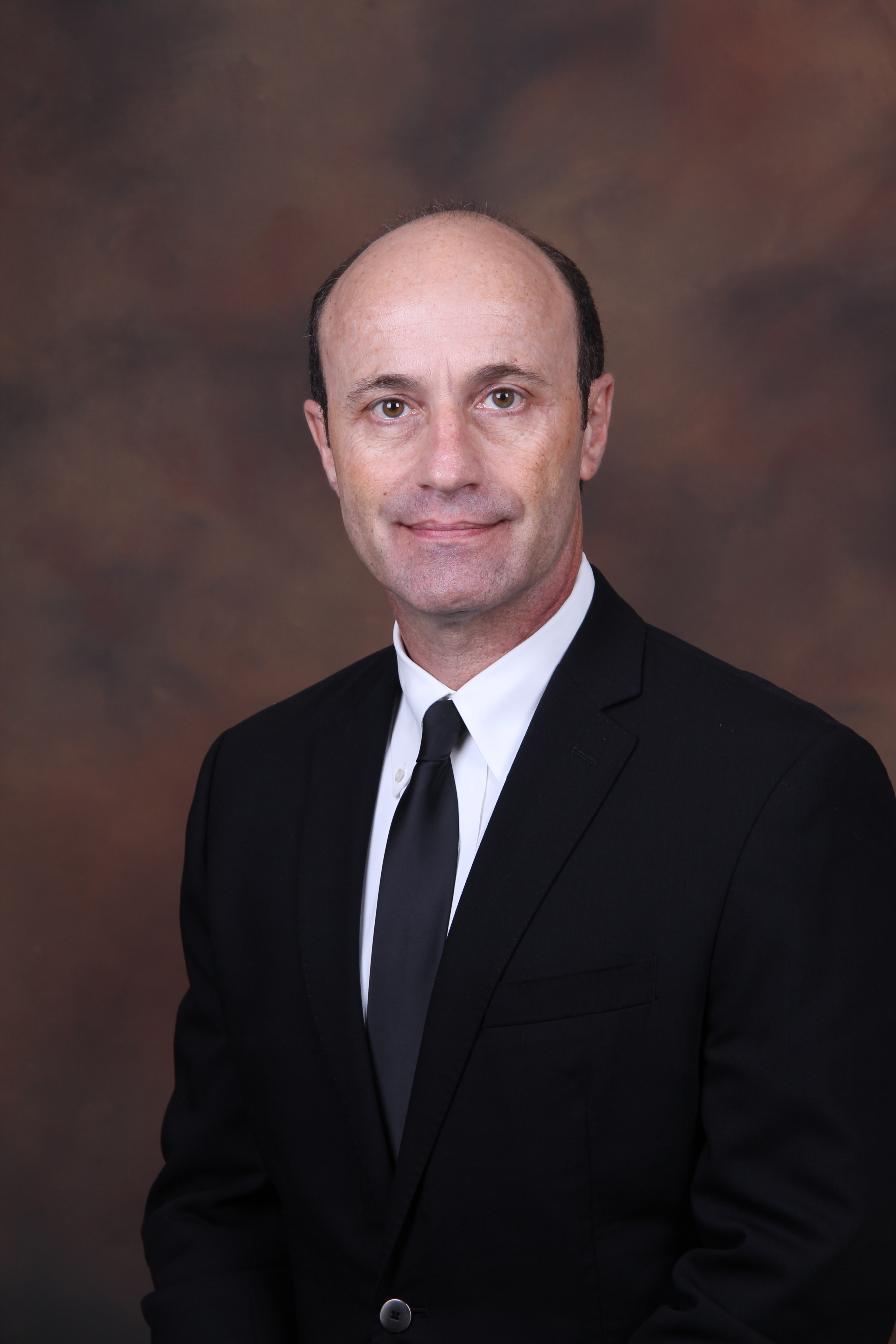A person wearing a suit and tieDescription automatically generated