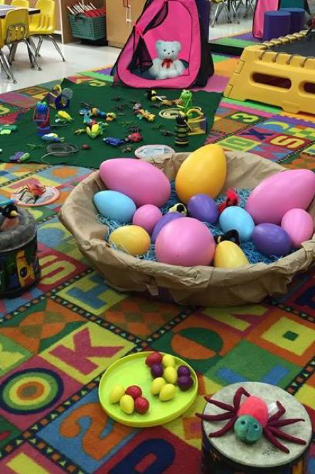 Block patterned carpet with tactile toys in a large basket