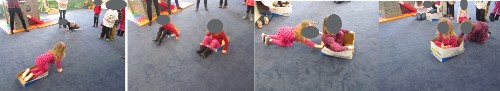 Children using printer boxes and lids to have Box Car Races.