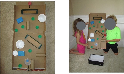 A maze made from a pizza box and other recycled materials.