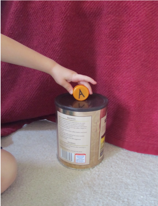 Putting caps through slots in recycled containers.