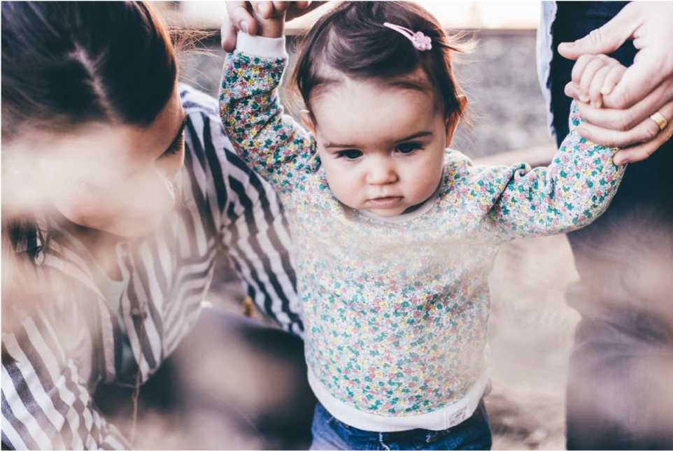 Young girl standing with help