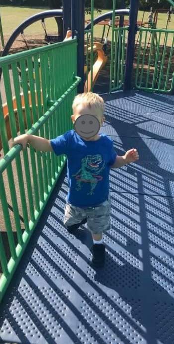 Young boy on playground equipment