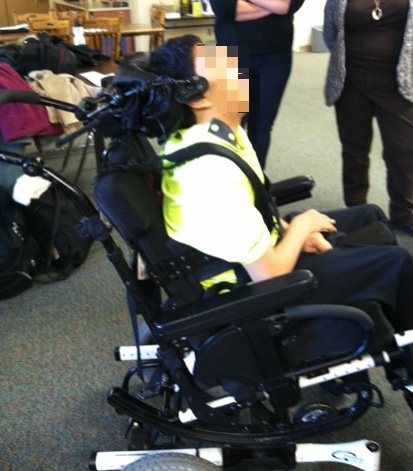 Kian in his seating system prior adjustment with poor head position.