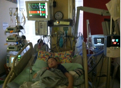 Author's son with all his medical equipment