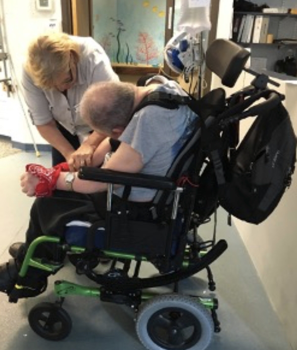 Gentleman in a wheelchair with severe forward head and neck position